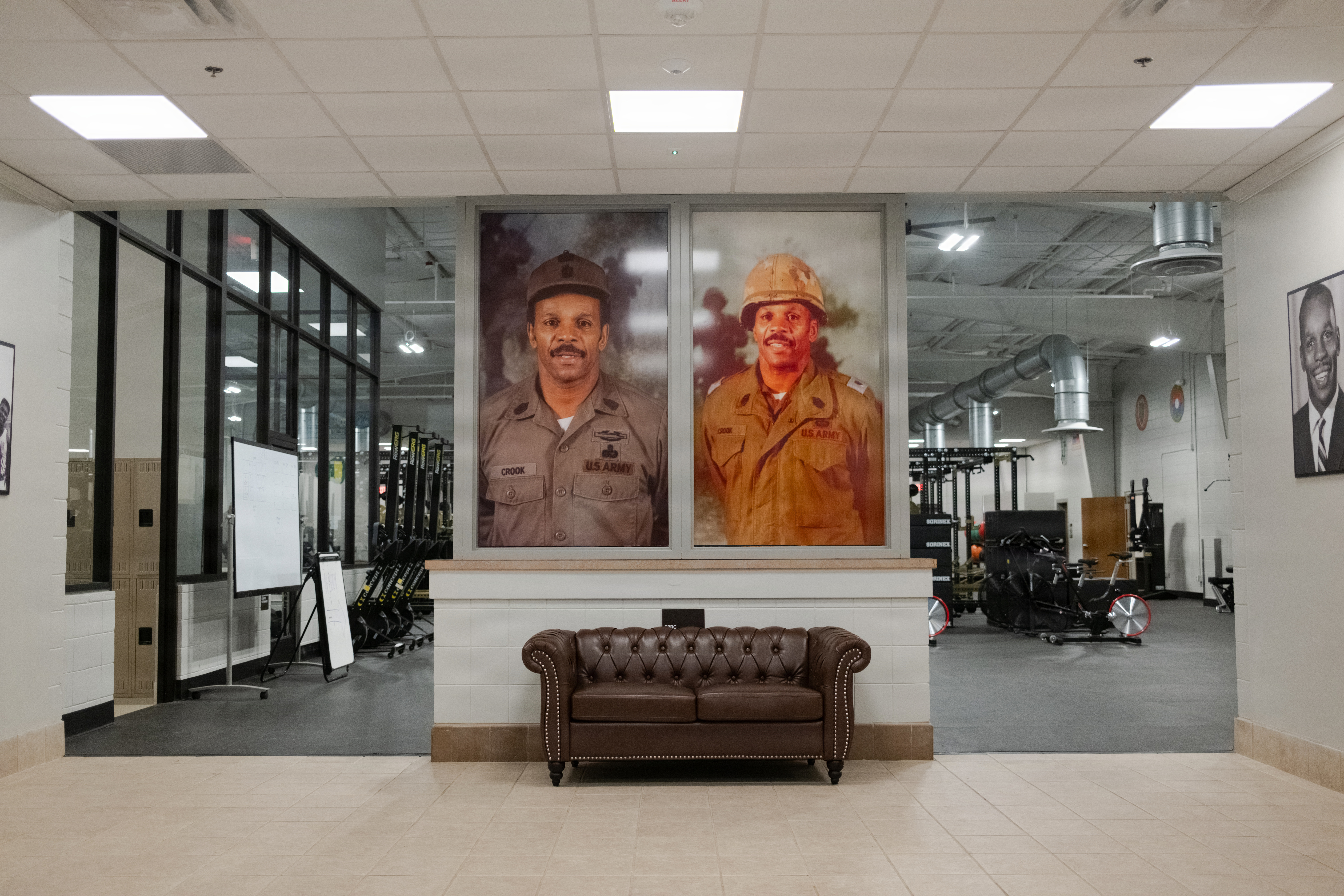 Larger-than-life photos of the late Command Sgt. Maj. Edward “Eddie” Crook Jr. hang in the Soldier Performance Readiness Center at Fort Benning, Ga., Feb. 27, 2026. The building was officially named in Crook’s honor during a ceremony attended by his family, Fort Benning leaders, and community members.
